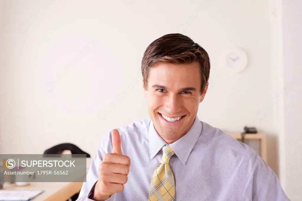 Portrait of businessman with thumbs up