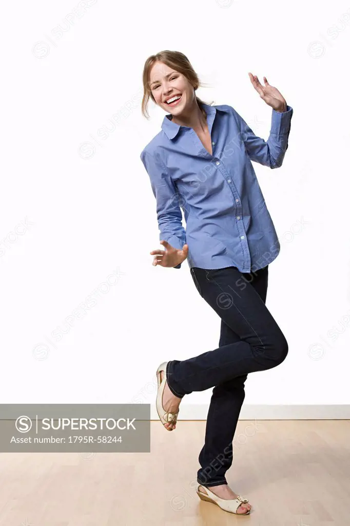 Studio portrait of young woman dancing