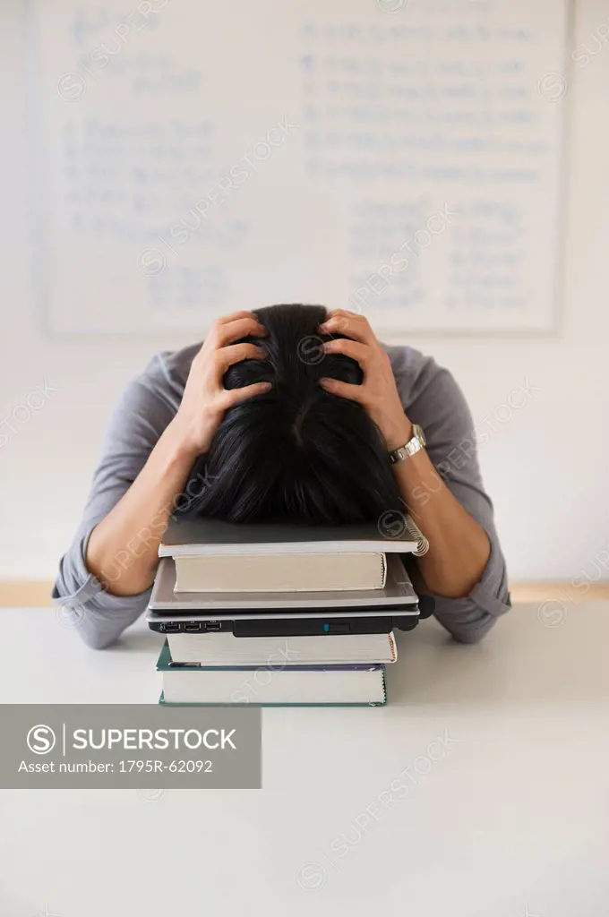 Frustrated woman in front of board with equations