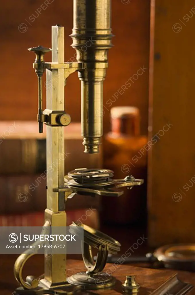 Old fashioned microscope on table