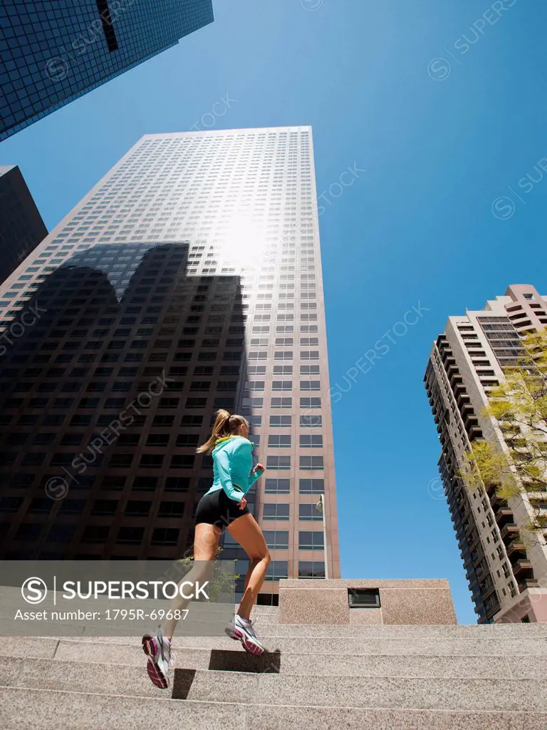 USA, California, Los Angeles, Young woman running on stairs