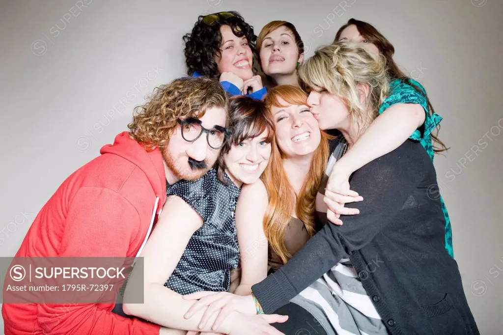 Group of young people in party mood posing together for portrait