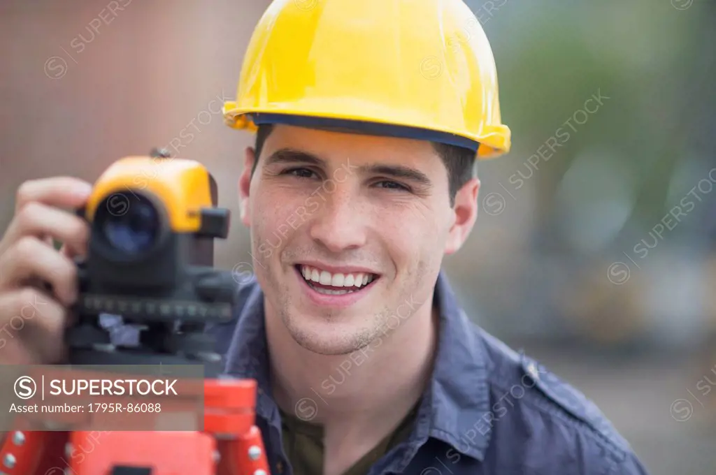 Engineer using theodolite