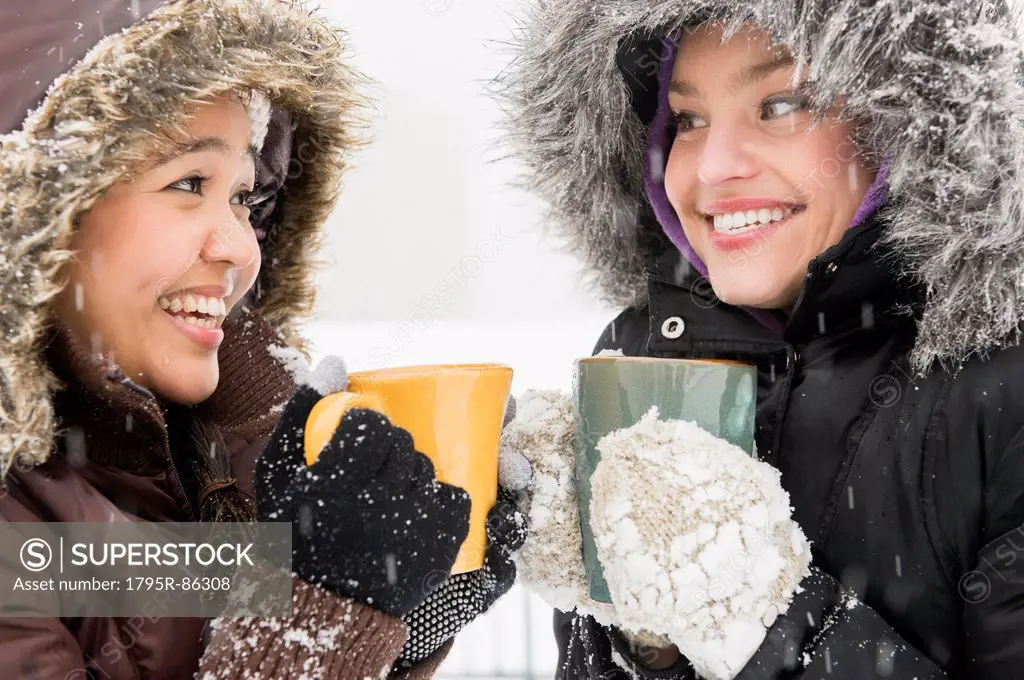 Two young women drinking hot chocolate