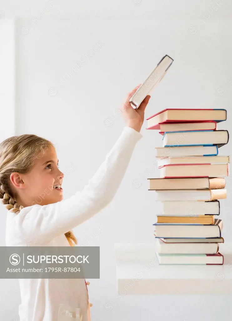 Portrait of girl (8-9) holding book