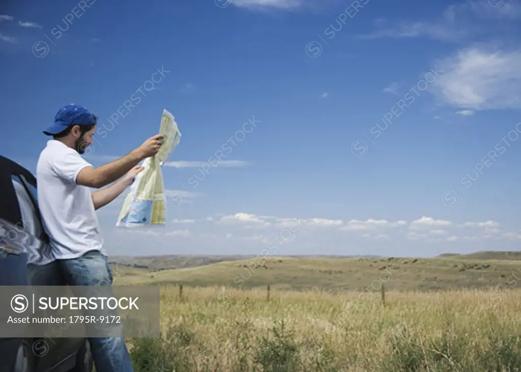 Man reading a map outdoors