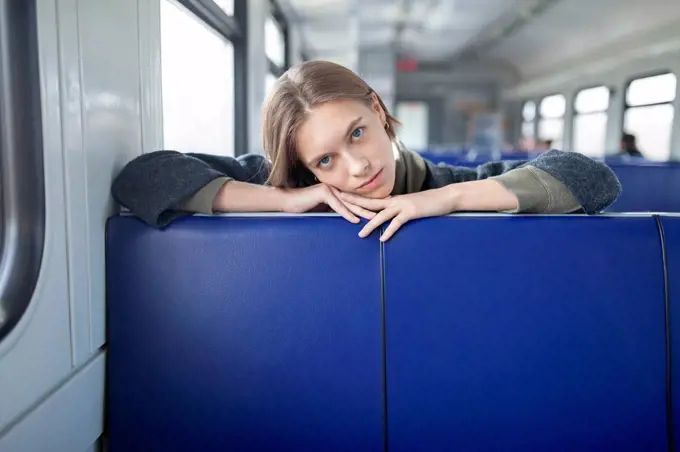 Portrait of young woman in train