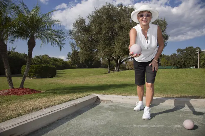 Senior Caucasian woman playing bocce ball