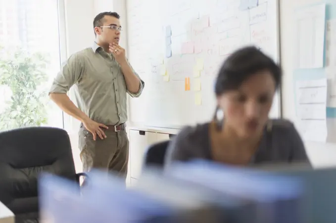 Two people working in office