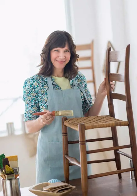 Woman restoring antique furniture