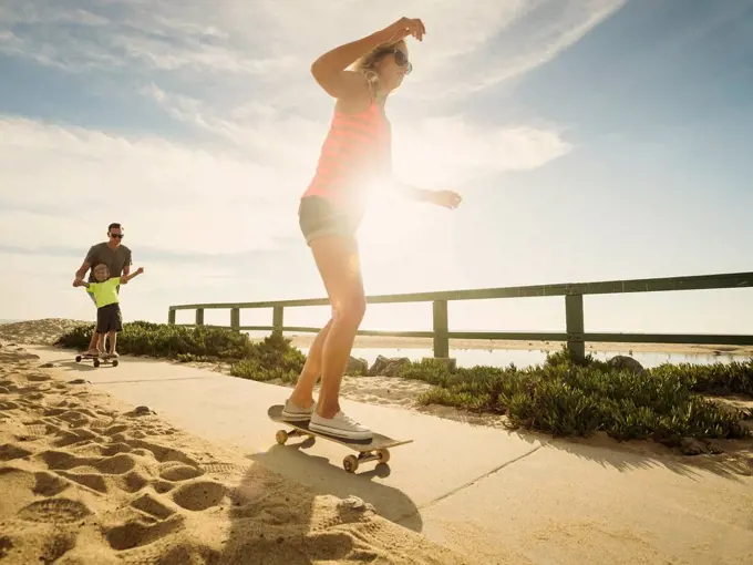 Parents skateboarding with their son (6-7)