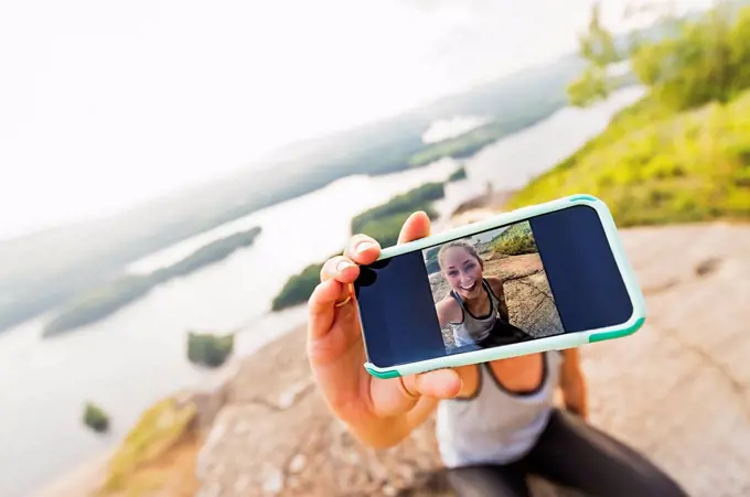 Young woman taking selfie on Smartphone