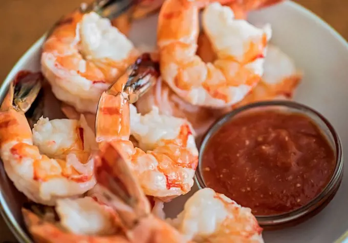 Shrimps and cocktail sauce in bowl