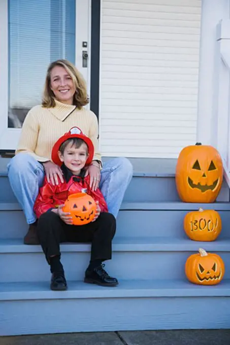 Mother and son dressed in fireman Halloween costume