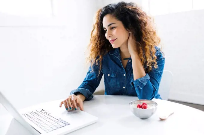 Woman using laptop at table