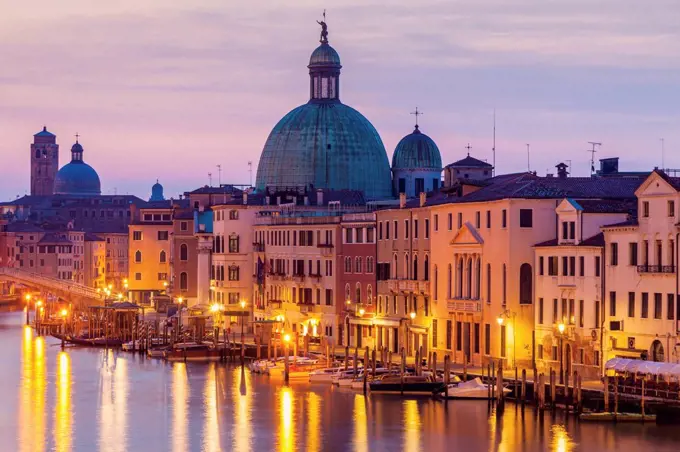 Italy, Veneto, Venice, Street light reflecting in water with Dome of Santa Maria della Salute Basilica