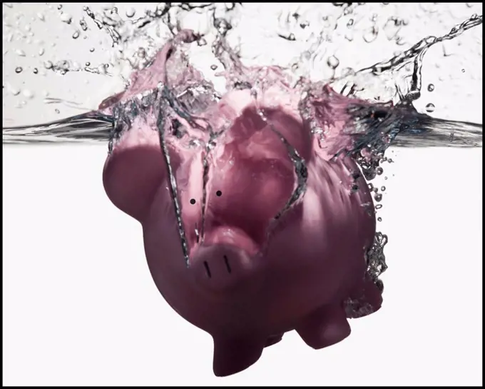 Piggy bank sinking in water