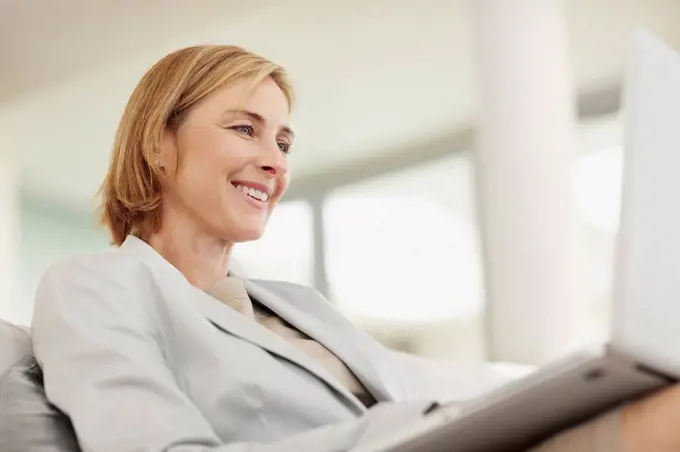 Mature business woman using laptop