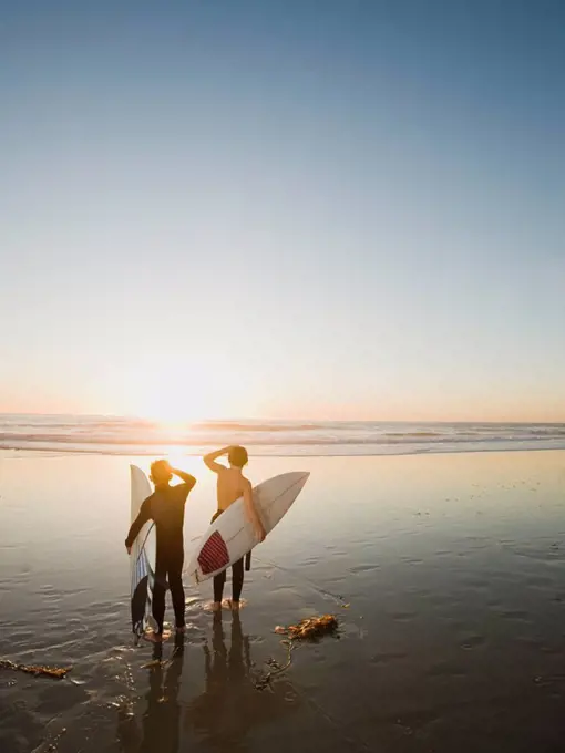 Kids on beach with surfboards