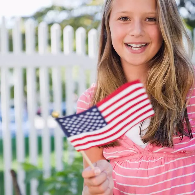 USA, New York, Girl 10_11 holding American flag