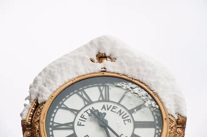 USA, New York, New York City, close up of antique clock covered with snow