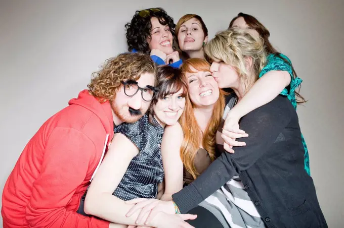 Group of young people in party mood posing together for portrait