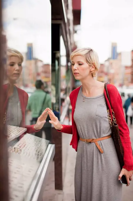 Woman looking at shop display