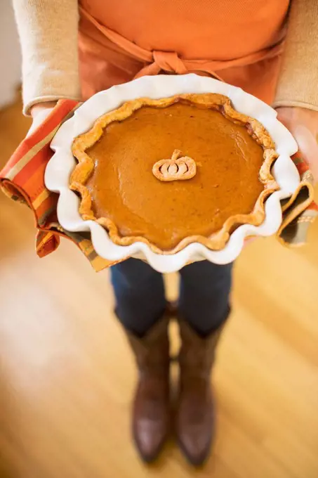 Woman holding pumpkin pie