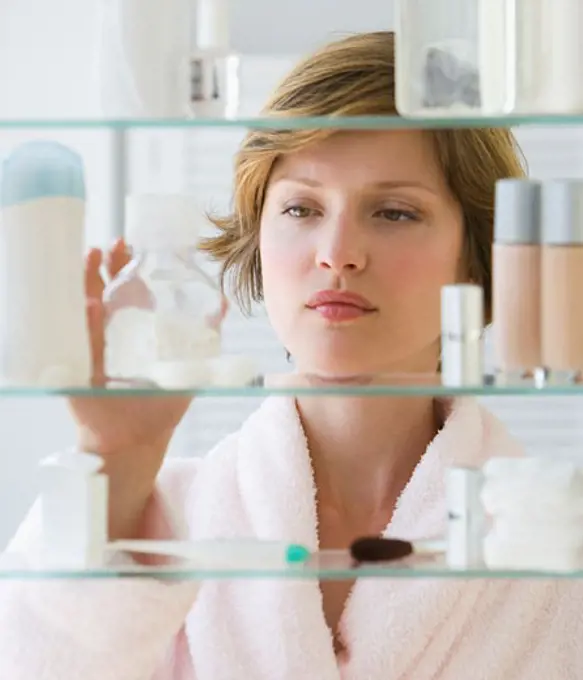 Woman looking in medicine cabinet