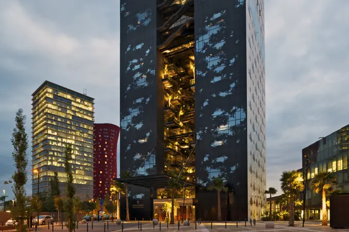 Renaissance Barcelona Fira Hotel, Barcelona, Spain. Architect: Jean Nouvel, 2012. Evening view of front elevation and entrance.