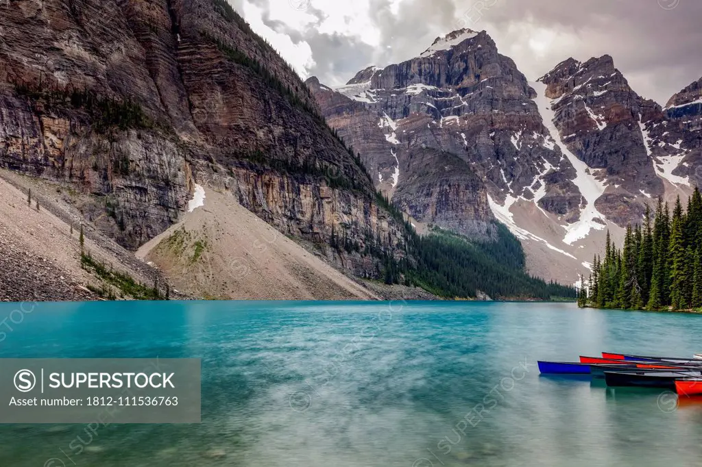 Turquoise water of a tranquil lake in the Rocky mountains, Jasper National Park; Alberta, Canada