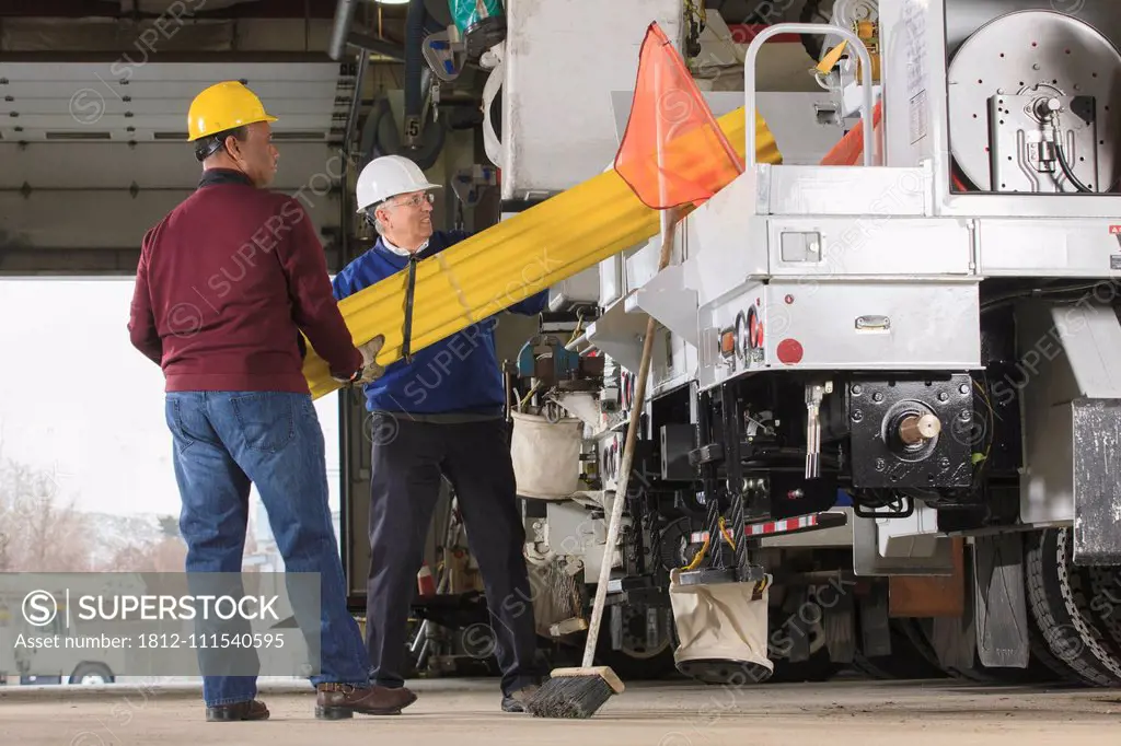 Maintenance supervisors preparing to load shielding onto utility truck