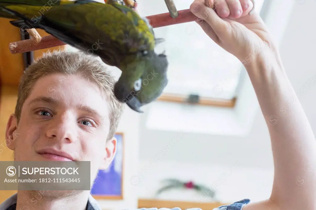 Boy with Anxiety Disorder playing with his pet bird