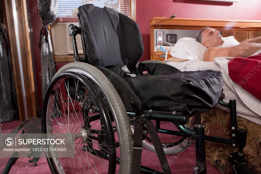 Man with spinal cord injury sleeping on the bed