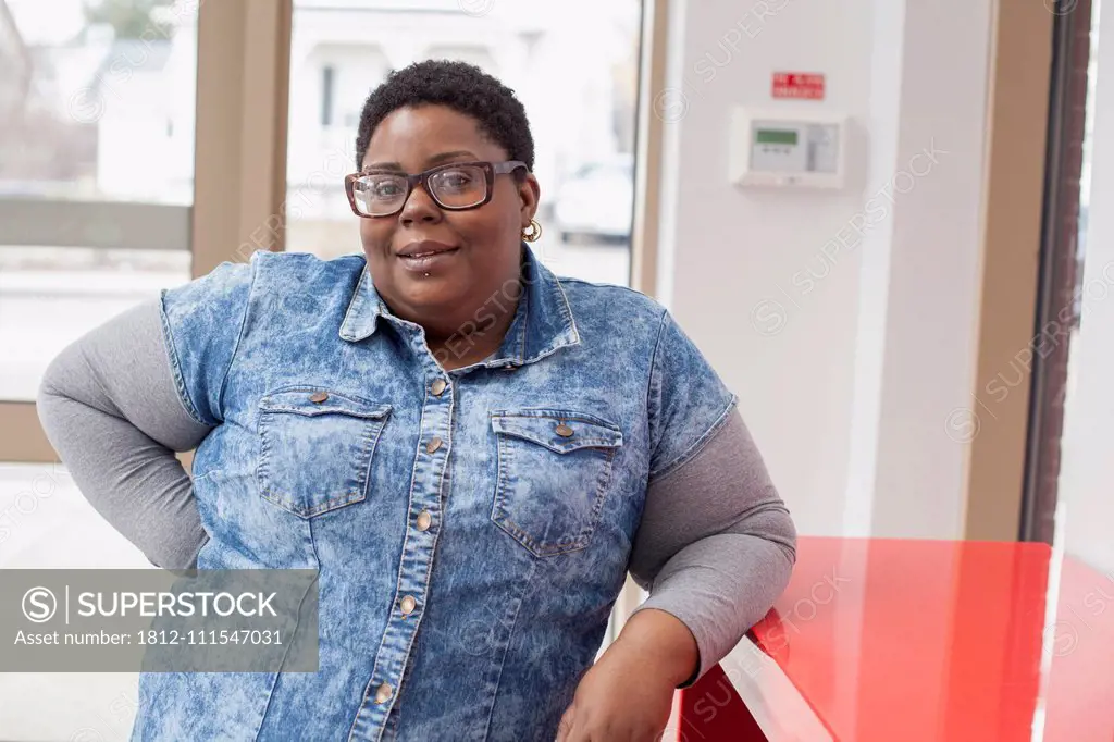 Portrait of a happy woman with bipolar disorder at her bank