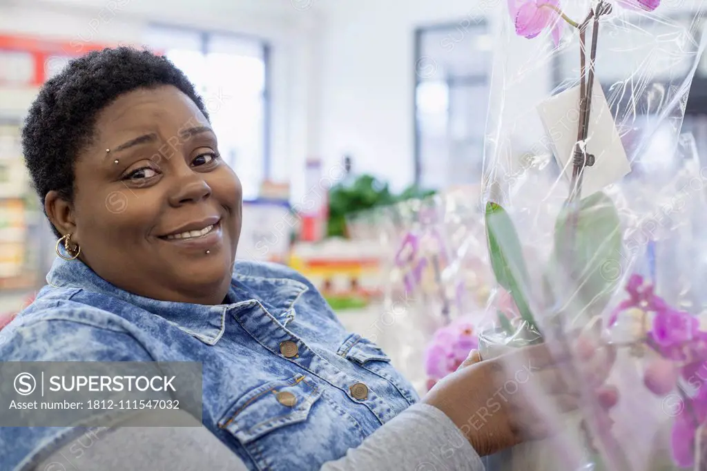 Portrait of a happy woman with bipolar disorder shopping for flowers