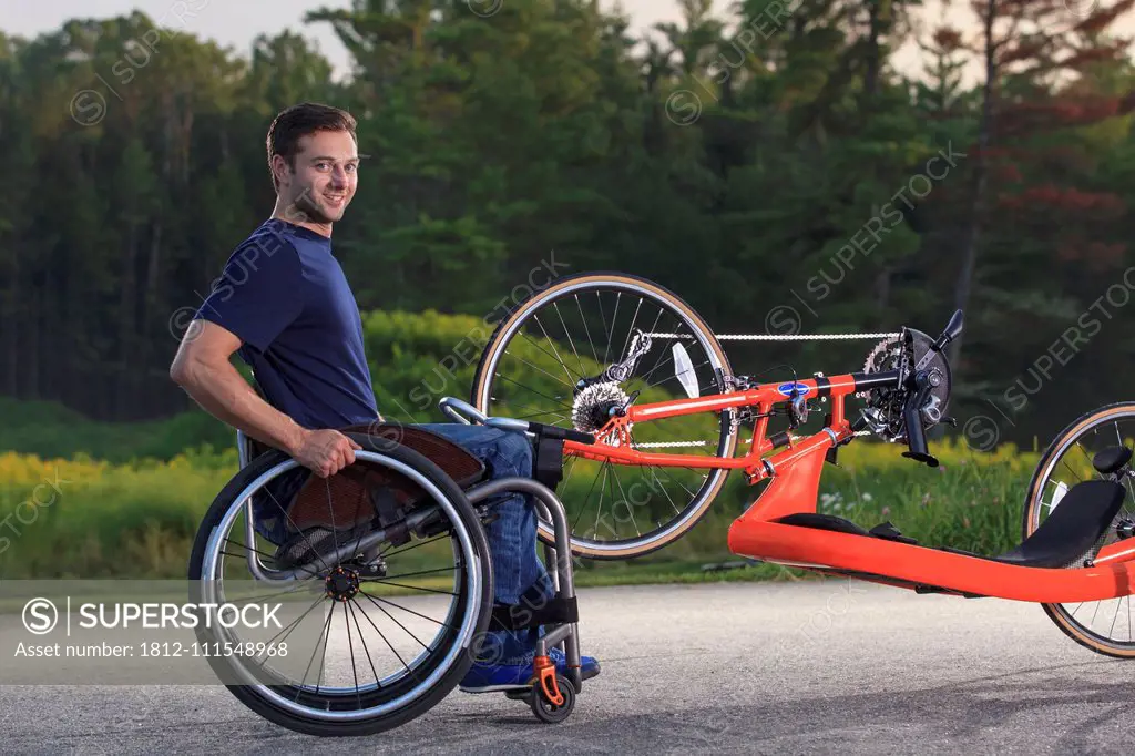 Man with spinal cord injury in his wheelchair with his custom adaptive hand cycle