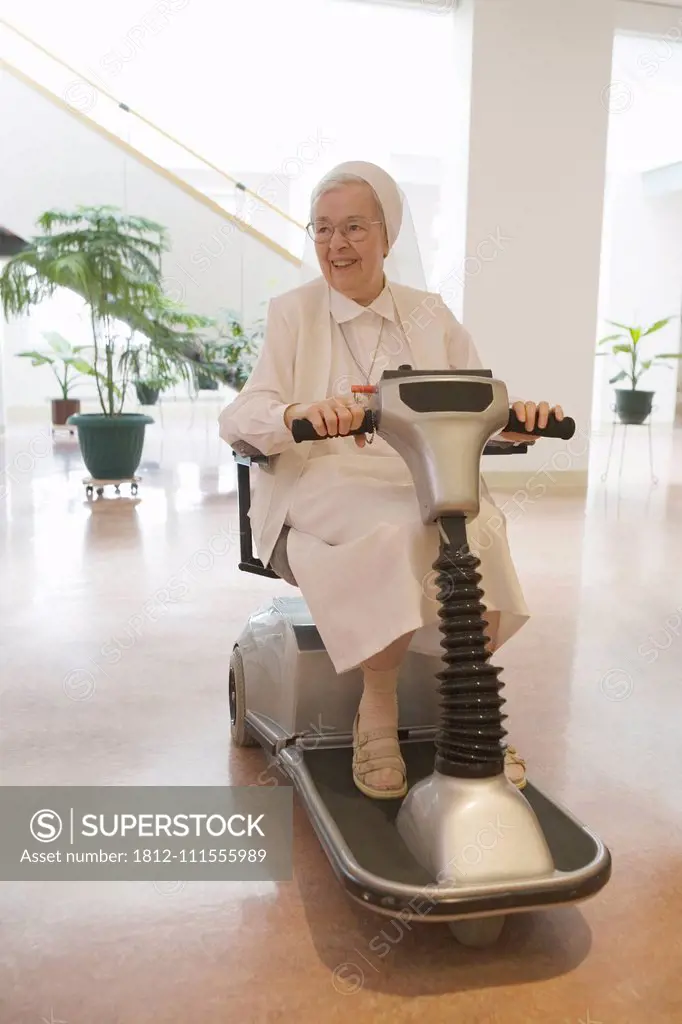 Nun riding a motorized wheelchair