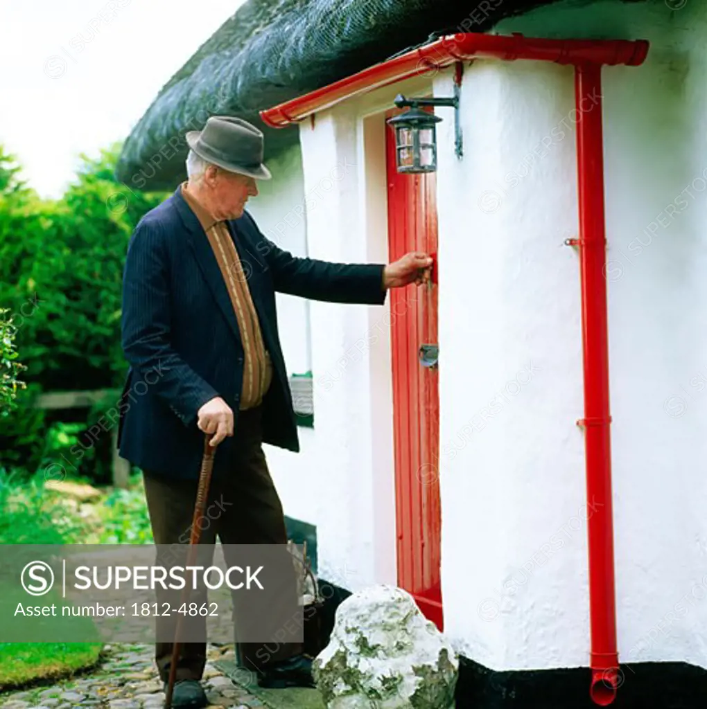 Old Man Opening Door, Thatched Cottage Ireland