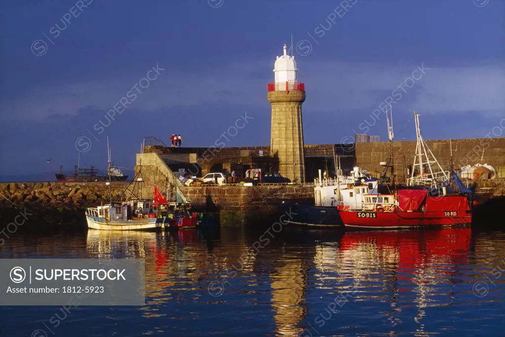 Dunmore East Harbour, County Waterford, Ireland; Fishing trawlers and lighthouse