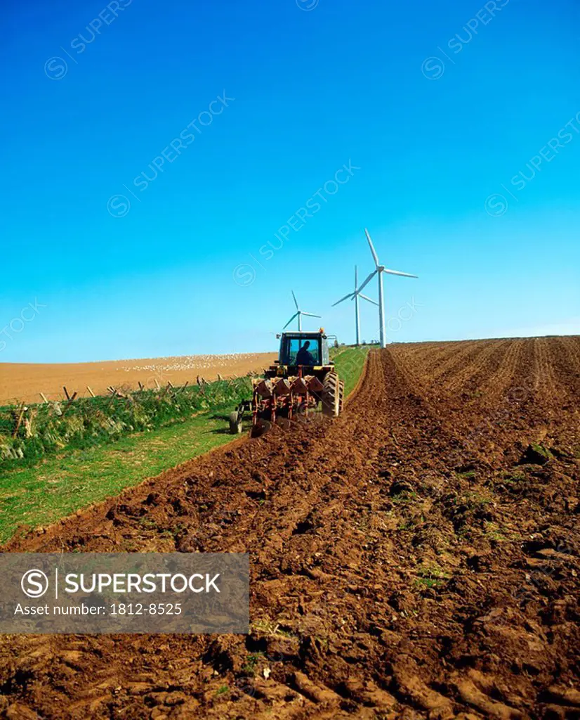 Wind Power, Tractor with a wind turbine in the distance