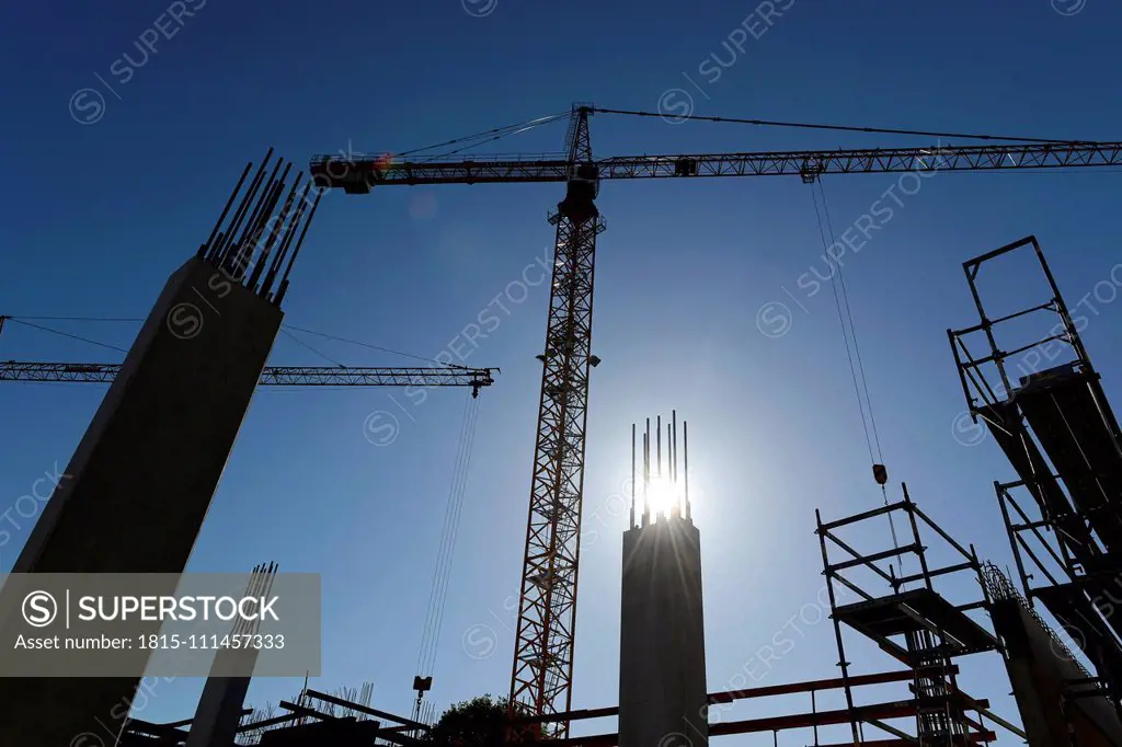 Germany, Bavaria, Geretsried, construction site, crane against the sun