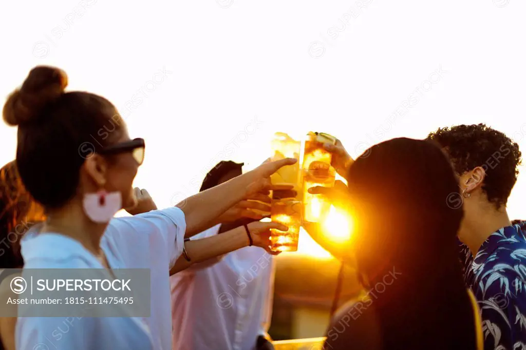 Group of happy multi-ethnic friends celebrating a party in the evening