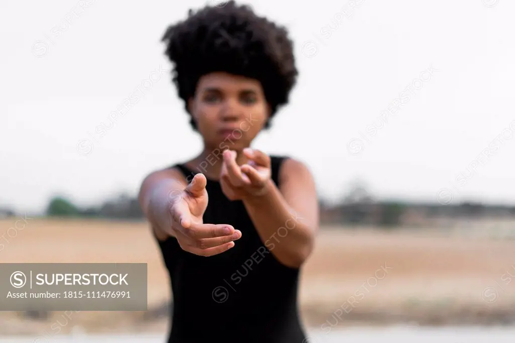 Woman's hands reaching out for help, pointing on viewer