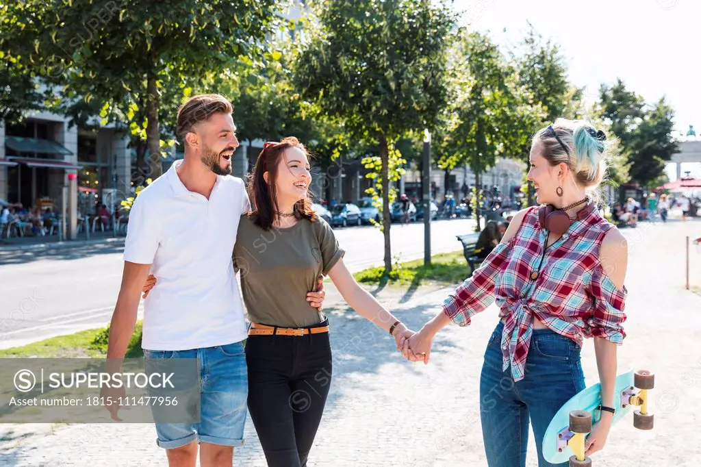 Three friends strolling together having fun