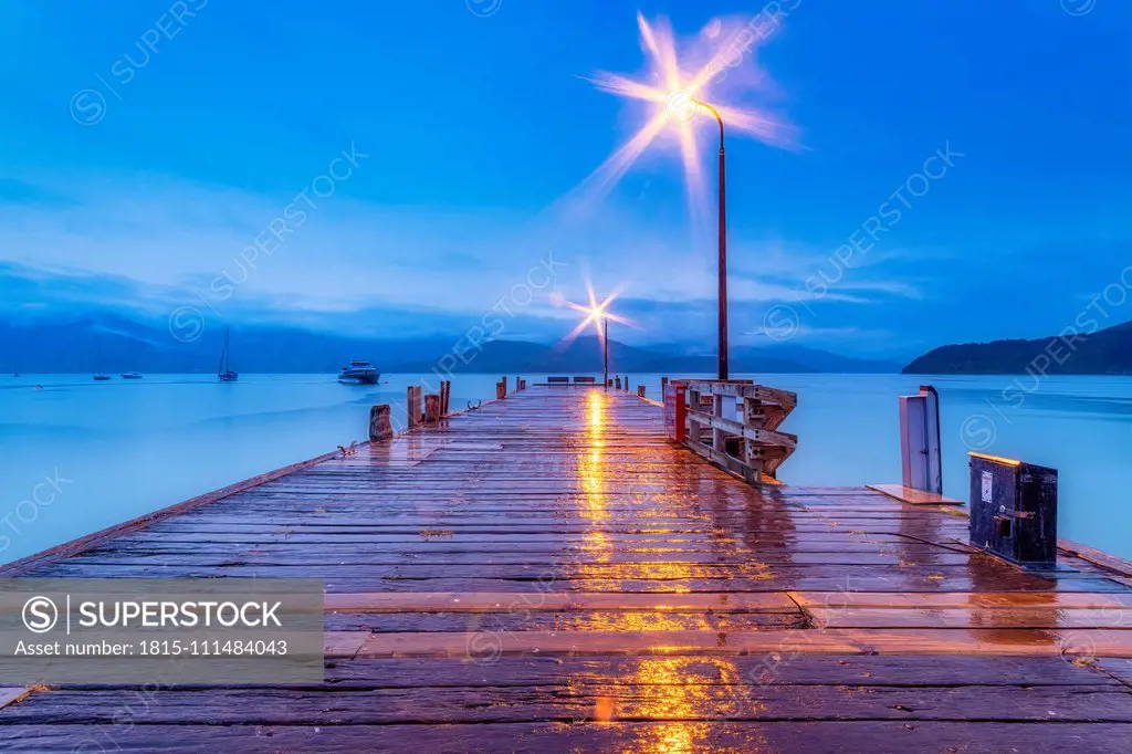 New Zealand, South Island, Akaroa, wooden pier at night