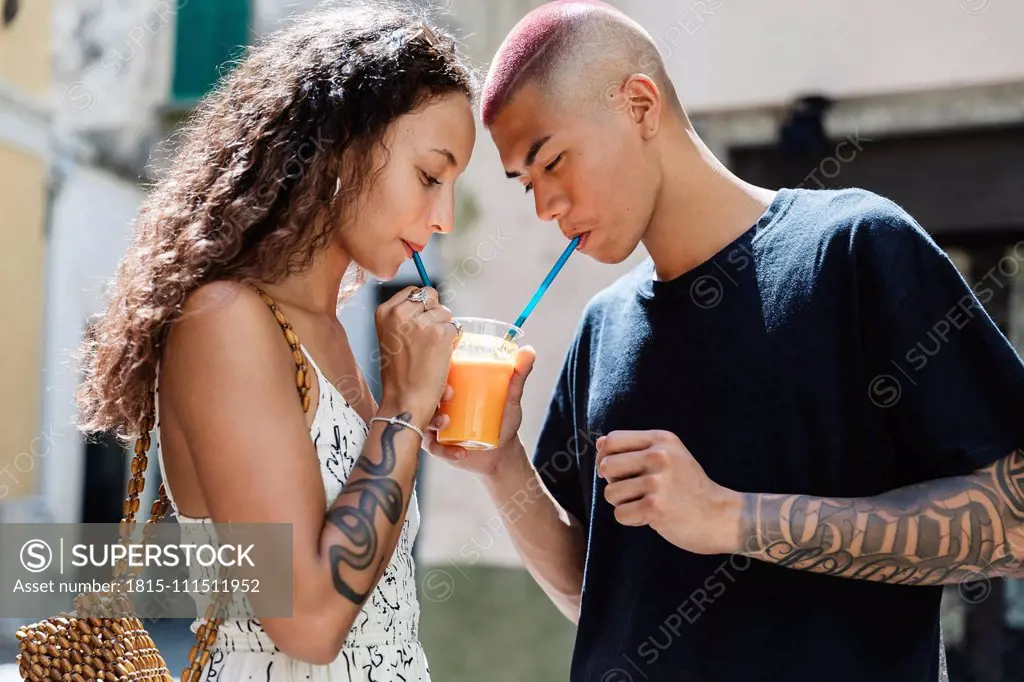 Young couple drinking fruit juice together