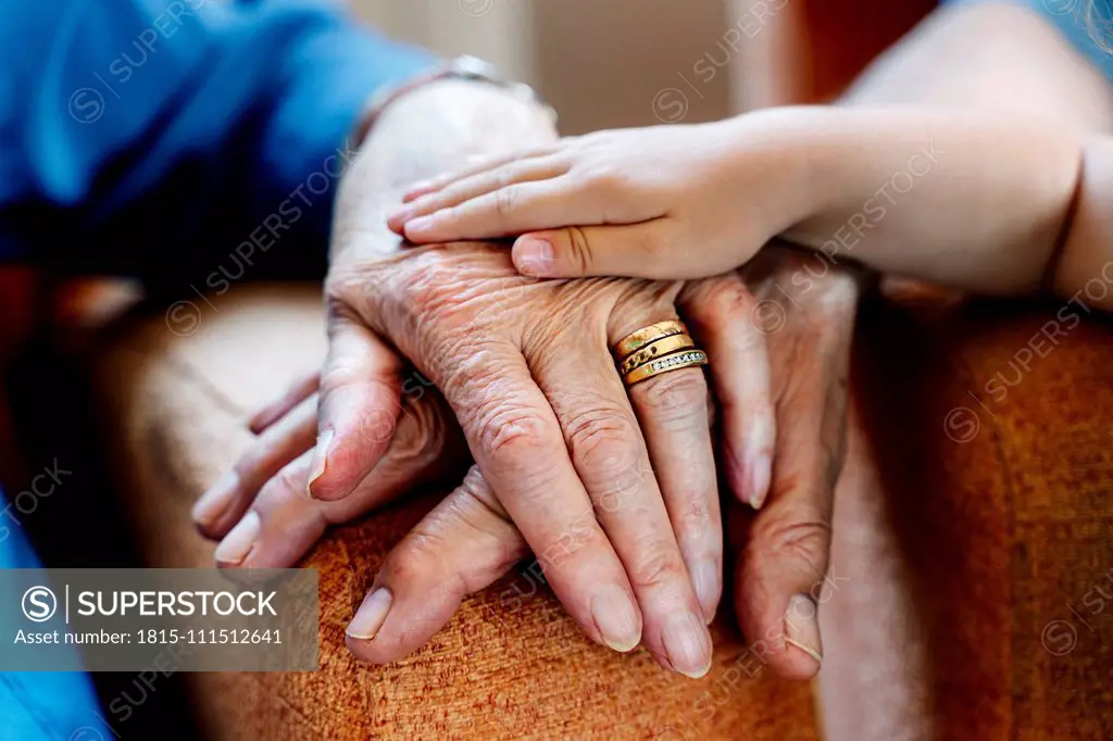 Elderly couple and baby's hand, generations together