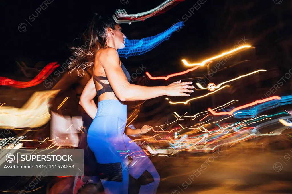 Woman running in the city at night