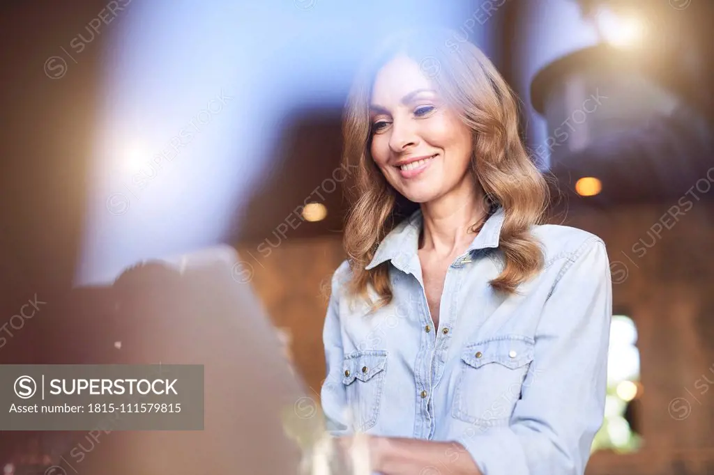 Business woman using laptop in a cafe